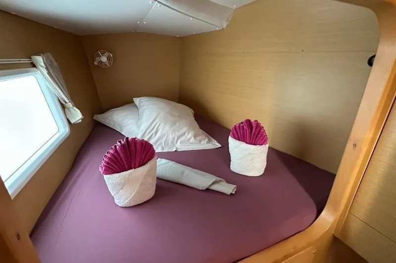 Nacrite Yacht Photos Pics Cozy cabin bed in 2018 Lagoon 380 catamaran with decorative towel arrangements.