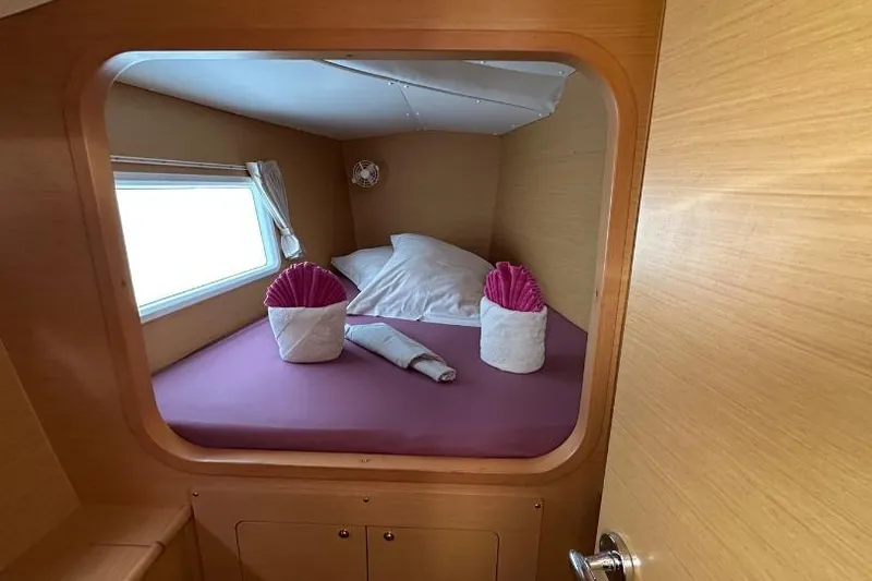 Nacrite Yacht Photos Pics Cozy cabin interior of 2018 Lagoon 380 catamaran with neatly arranged bed and towels.