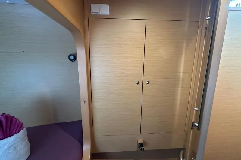 Nacrite Yacht Photos Pics Interior of 2018 Lagoon 380 catamaran with wooden cabinetry and cozy seating area.