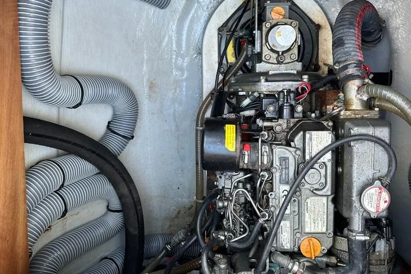 Nacrite Yacht Photos Pics Engine compartment of a 2018 Lagoon 380 catamaran with visible hoses and components.