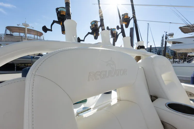 Resolute Yacht Photos Pics 2017 Regulator 31 boat seats with fishing rods in marina setting.