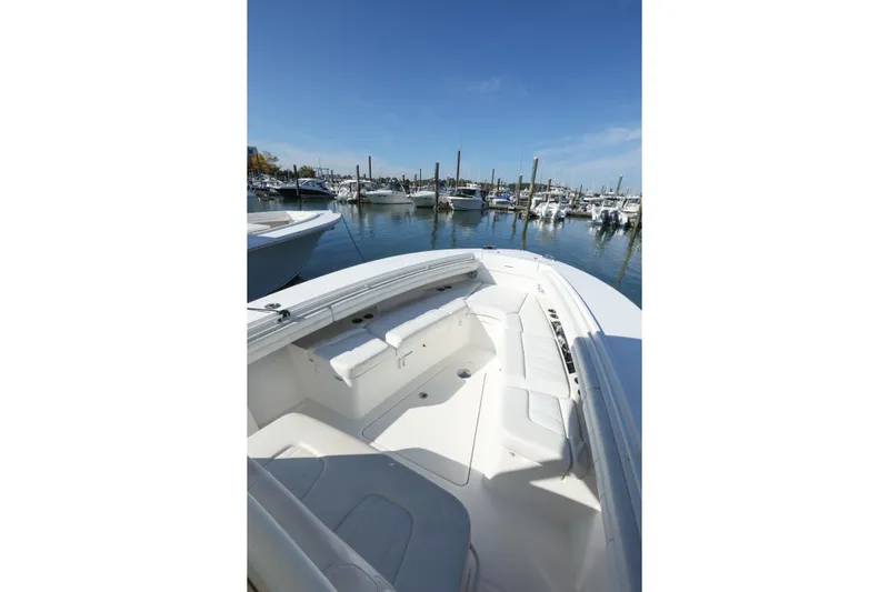 Resolute Yacht Photos Pics 2017 Regulator 31 boat interior at marina, showcasing seating and clear blue sky.