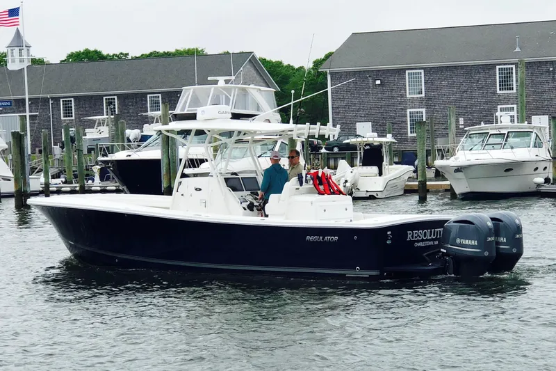 Resolute Yacht Photos Pics 2017 Regulator 31 boat docked, featuring twin Yamaha engines, in a marina setting.