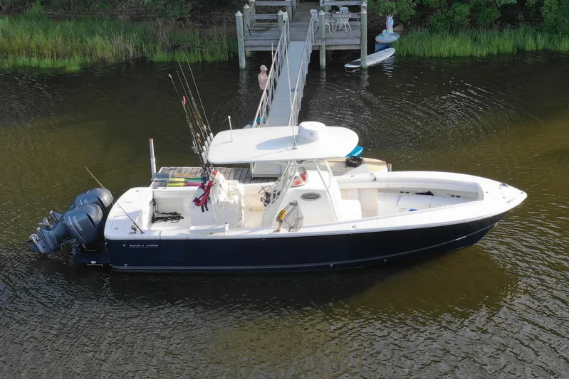 Resolute Yacht Photos Pics 2017 Regulator 31 boat docked with fishing rods and twin engines.