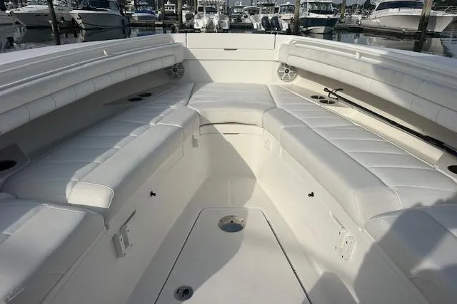 Resolute Yacht Photos Pics 2017 Regulator 31 boat interior with white cushioned seating and marina background.