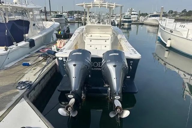 Resolute Yacht Photos Pics 2017 Regulator 31 boat docked with twin outboard engines in a marina.