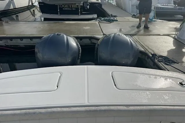 Resolute Yacht Photos Pics 2017 Regulator 31 boat with dual outboard engines at a dock.