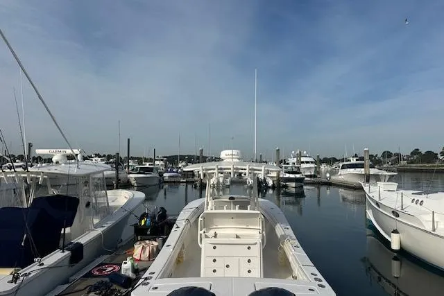 Resolute Yacht Photos Pics 2017 Regulator 31 boat docked in a marina with other vessels.