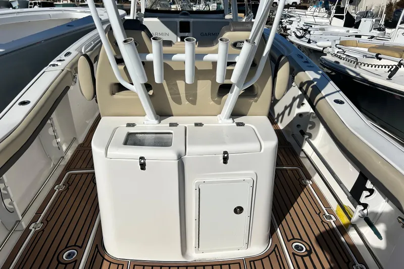  Yacht Photos Pics 2020 Tidewater 320 CC Adventure boat interior with rod holders and teak flooring.