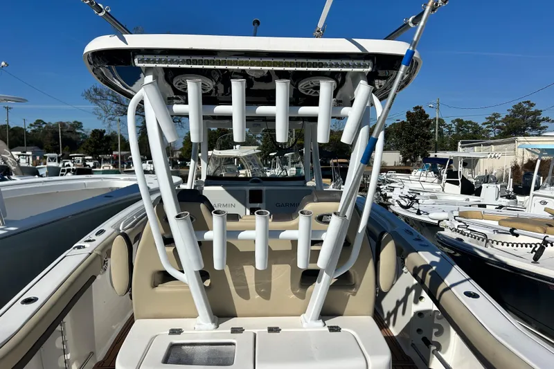  Yacht Photos Pics 2020 Tidewater 320 CC Adventure boat with rod holders and seating, docked in a marina.