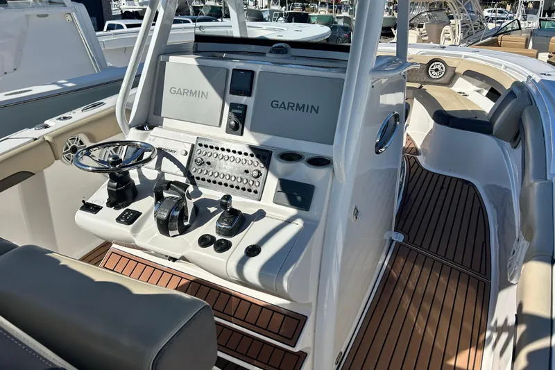  Yacht Photos Pics 2020 Tidewater 320 CC Adventure boat cockpit with Garmin navigation system and sleek controls.