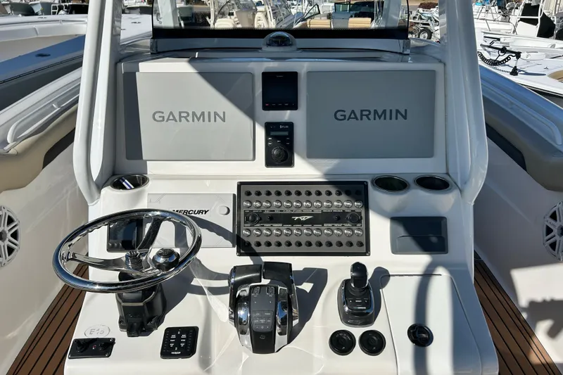  Yacht Photos Pics 2020 Tidewater 320 CC Adventure boat dashboard with Garmin displays and Mercury controls.