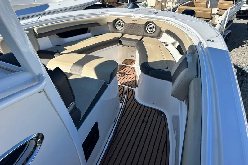  Yacht Photos Pics 2020 Tidewater 320 CC Adventure boat interior with cushioned seating and wood-style flooring.