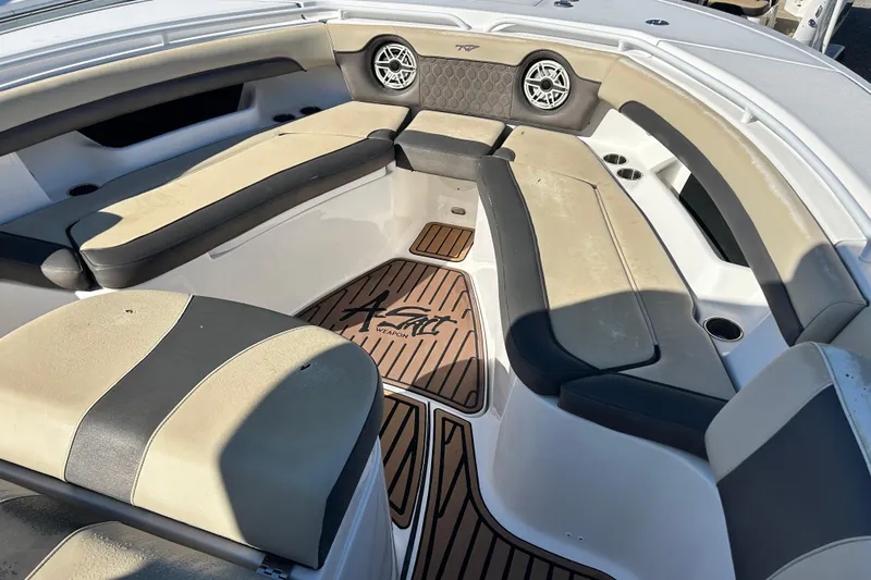  Yacht Photos Pics 2020 Tidewater 320 CC Adventure boat interior with cushioned seating and teak flooring.