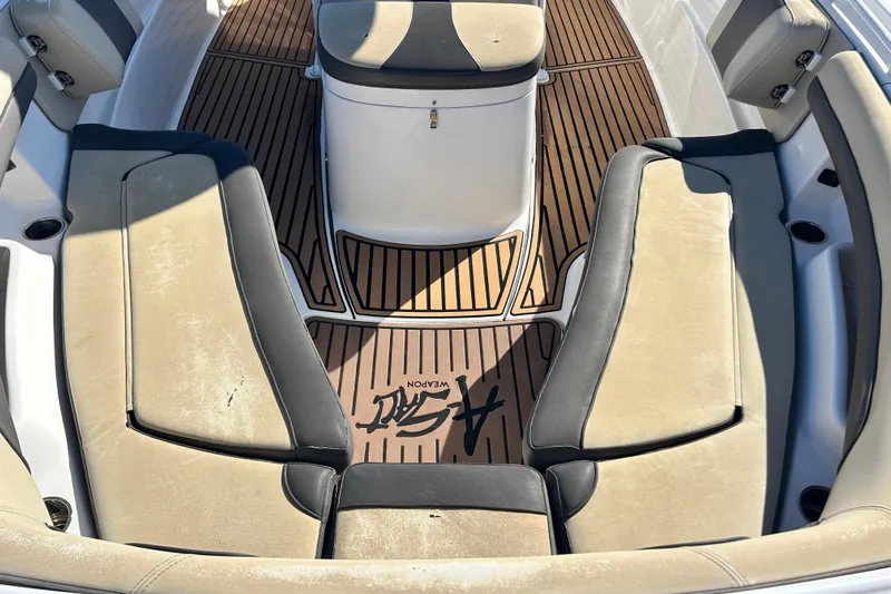  Yacht Photos Pics 2020 Tidewater 320 CC Adventure boat interior with cushioned seating and wood-style flooring.