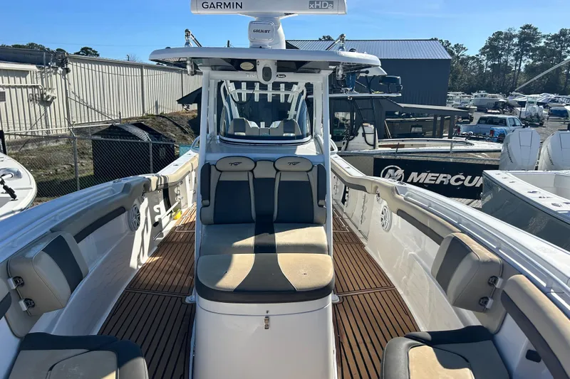  Yacht Photos Pics 2020 Tidewater 320 CC Adventure boat interior with seating and Garmin equipment.