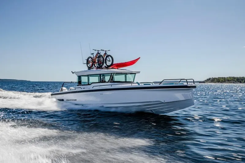  Yacht Photos Pics 2021 Axopar 37 XC Cross Cabin cruising with bikes and kayak on roof.
