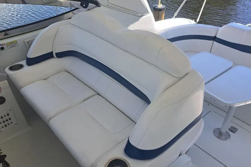 Wattever Yacht Photos Pics 2008 Formula 34 Performance Cruiser interior with white and blue seating, cup holders, and table.