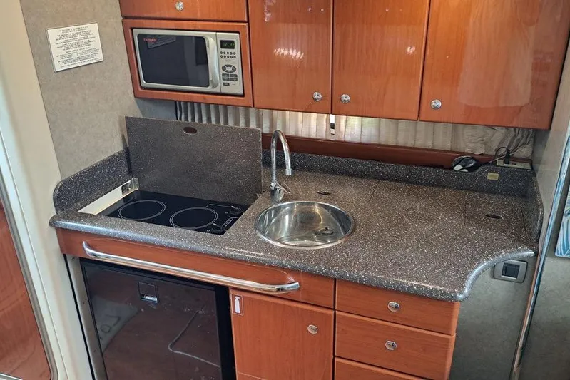 Wattever Yacht Photos Pics 2008 Formula 34 Performance Cruiser kitchen with microwave, sink, and stovetop.