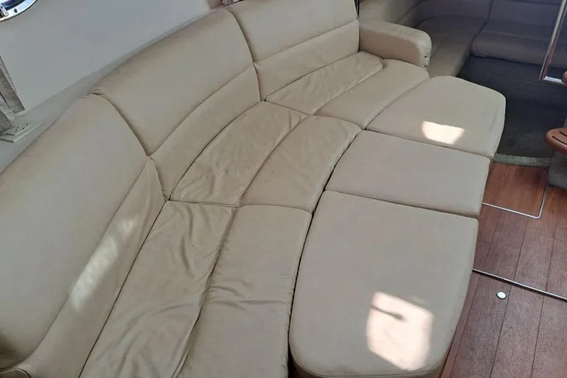 Wattever Yacht Photos Pics Beige interior seating of 2008 Formula 34 Performance Cruiser, featuring plush cushions and wooden flooring.