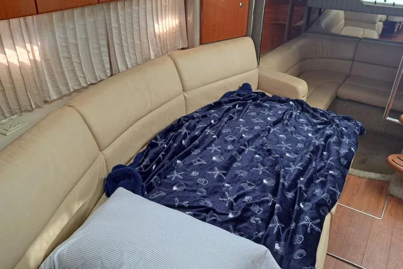 Wattever Yacht Photos Pics Interior of 2008 Formula 34 Performance Cruiser with beige seating and nautical-themed blanket.