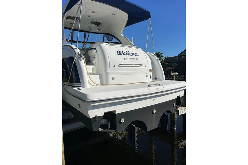 Wattever Yacht Photos Pics 2008 Formula 34 Performance Cruiser docked, rear view with blue canopy, Cape Coral, FL.