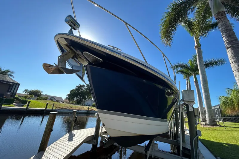Wattever Yacht Photos Pics 2008 Formula 34 Performance Cruiser on lift, sunny day, palm trees in background.