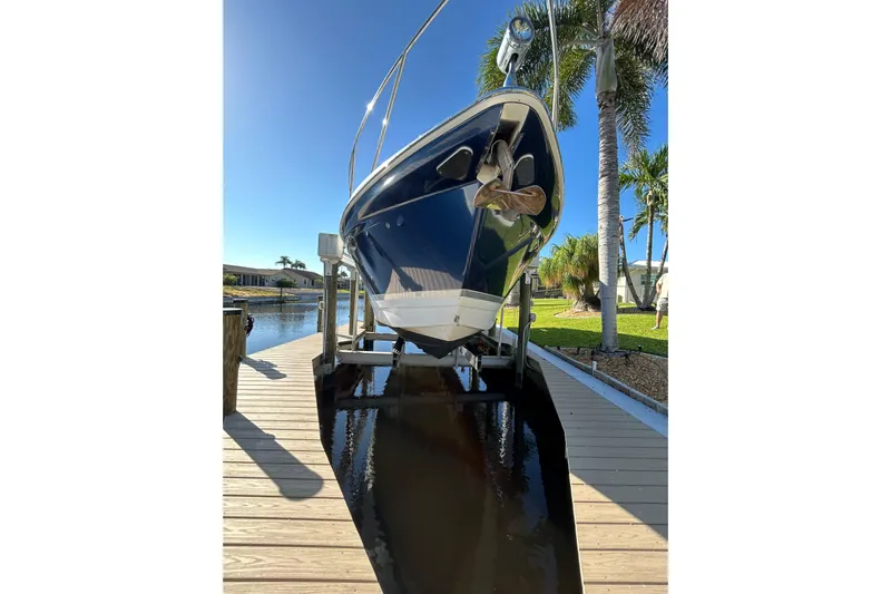 Wattever Yacht Photos Pics 2008 Formula 34 Performance Cruiser docked by a sunny waterfront with palm trees.