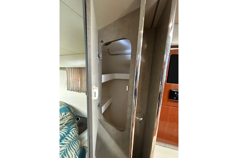 Wattever Yacht Photos Pics 2008 Formula 34 Performance Cruiser interior with open closet and tropical-patterned bedding.