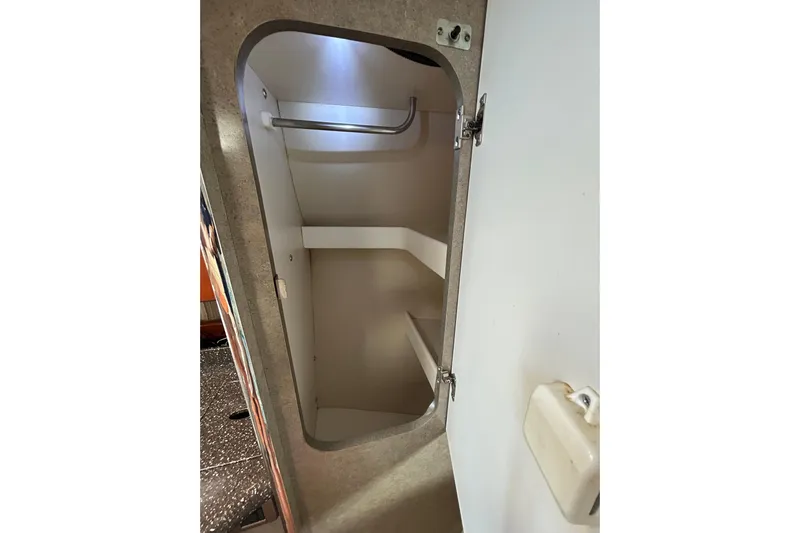 Wattever Yacht Photos Pics 2008 Formula 34 Performance Cruiser interior storage compartment with open door.