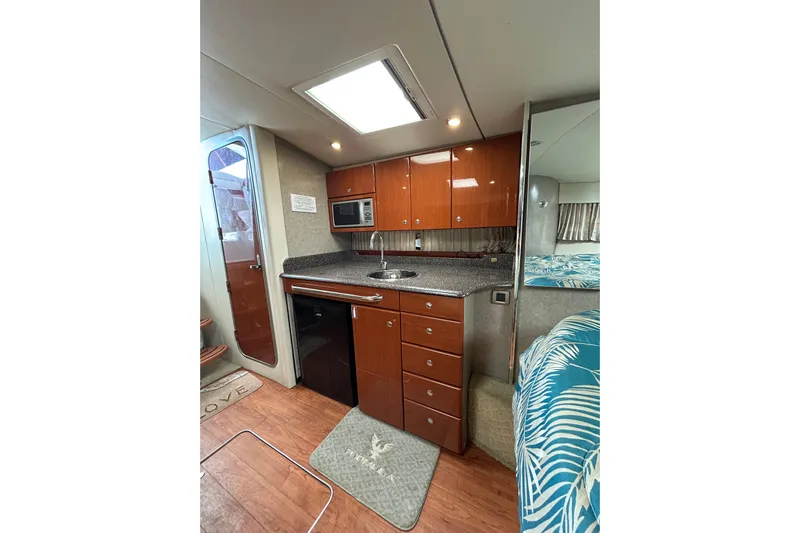 Wattever Yacht Photos Pics 2008 Formula 34 Performance Cruiser interior with kitchenette, wood cabinets, and modern appliances.