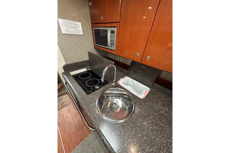 Wattever Yacht Photos Pics 2008 Formula 34 Performance Cruiser kitchen with sink, stove, and microwave.