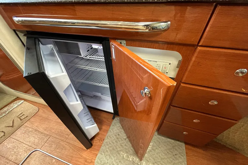 Wattever Yacht Photos Pics 2008 Formula 34 Performance Cruiser interior with open fridge and wooden cabinetry.