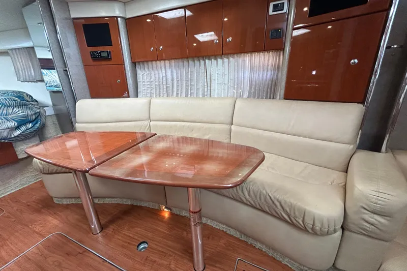 Wattever Yacht Photos Pics Luxurious interior of 2008 Formula 34 Performance Cruiser with leather seating and wooden table.