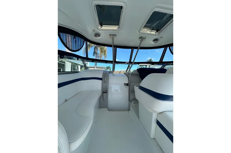 Wattever Yacht Photos Pics Interior of 2008 Formula 34 Performance Cruiser with white seating and blue accents.
