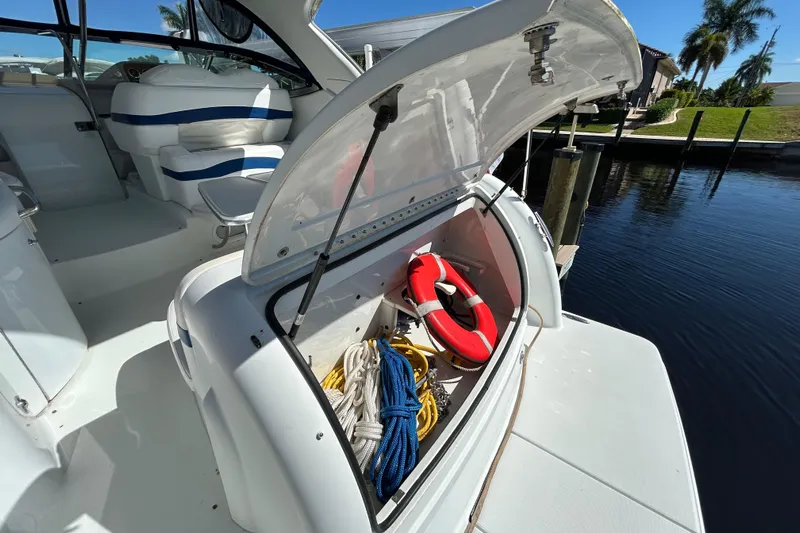 Wattever Yacht Photos Pics 2008 Formula 34 Performance Cruiser with open storage, life ring, and ropes by the water.