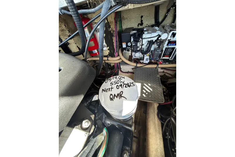 Wattever Yacht Photos Pics Engine compartment of a 2008 Formula 34 Performance Cruiser with maintenance notes.