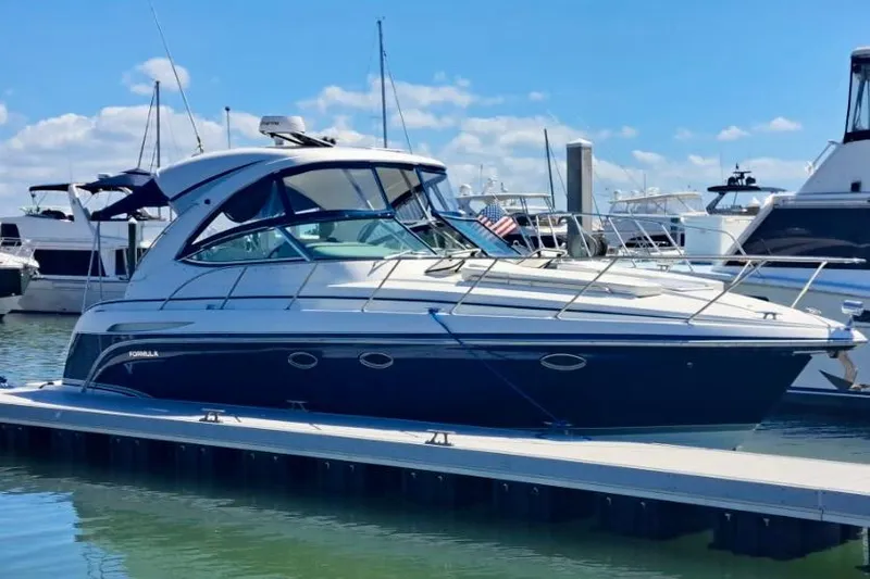 Wattever Yacht Photos Pics 2008 Formula 34 Performance Cruiser docked at marina under clear blue sky.