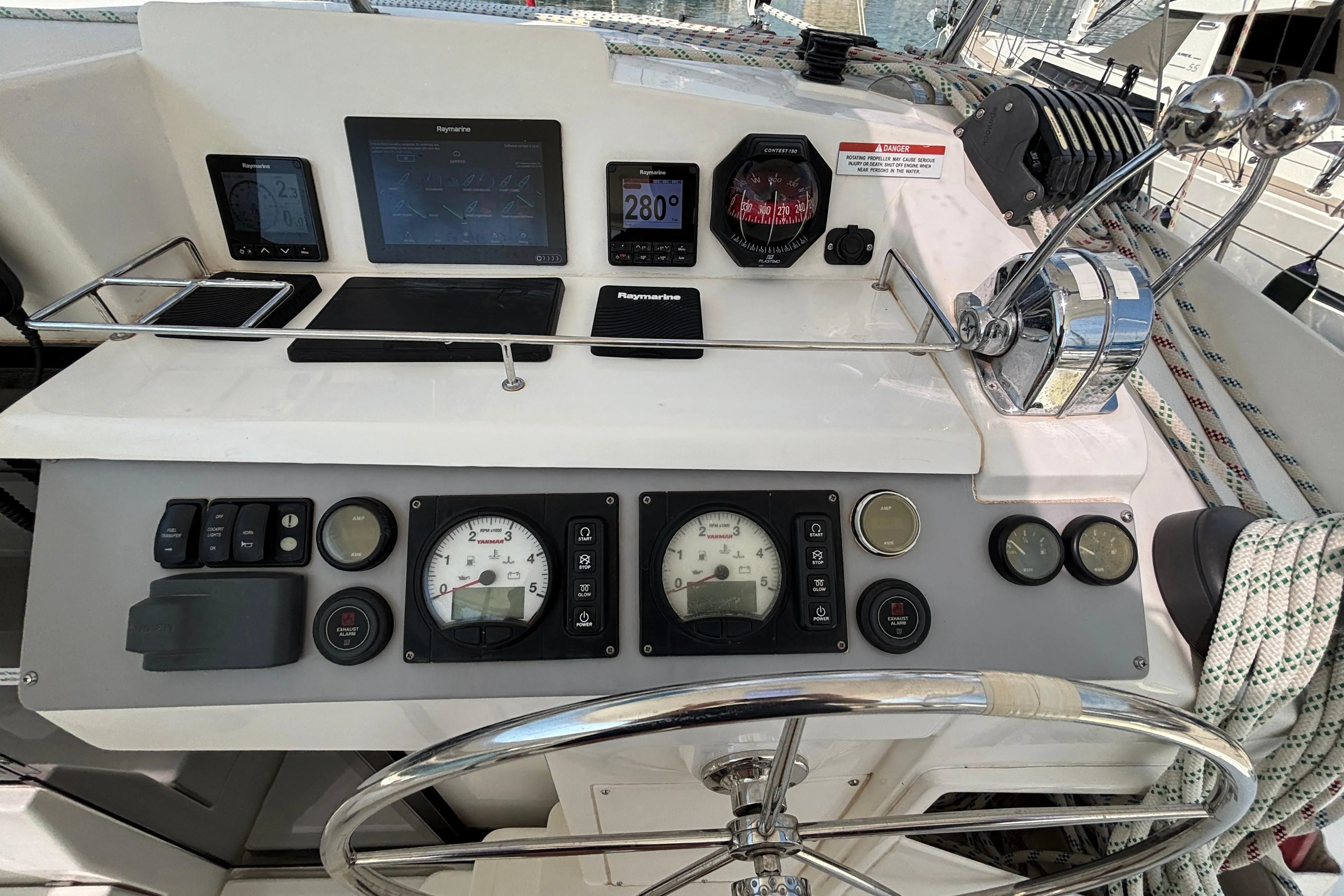 Control panel of a 2019 Leopard 40 catamaran with navigation instruments and steering wheel.