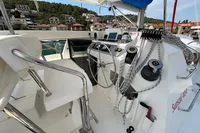 Cockpit of 2019 Leopard 40 catamaran with steering wheel, ropes, and controls.