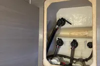 2019 Leopard 40 yacht plumbing system with valves and hoses in a compartment.