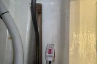 Bilge area of 2019 Leopard 40 with hoses and a float switch.