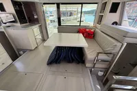 Interior of 2019 Leopard 40 catamaran with dining area and view of marina.