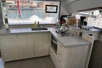 Modern kitchen interior on a 2019 Leopard 40 catamaran with scenic harbor view.