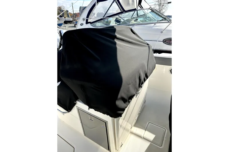  Yacht Photos Pics 2023 Boston Whaler OUTRAGE boat interior with covered console and windshield.
