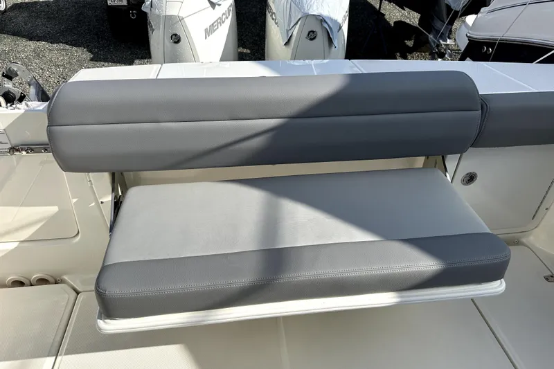  Yacht Photos Pics 2023 Boston Whaler OUTRAGE boat seat with gray upholstery and sleek design.