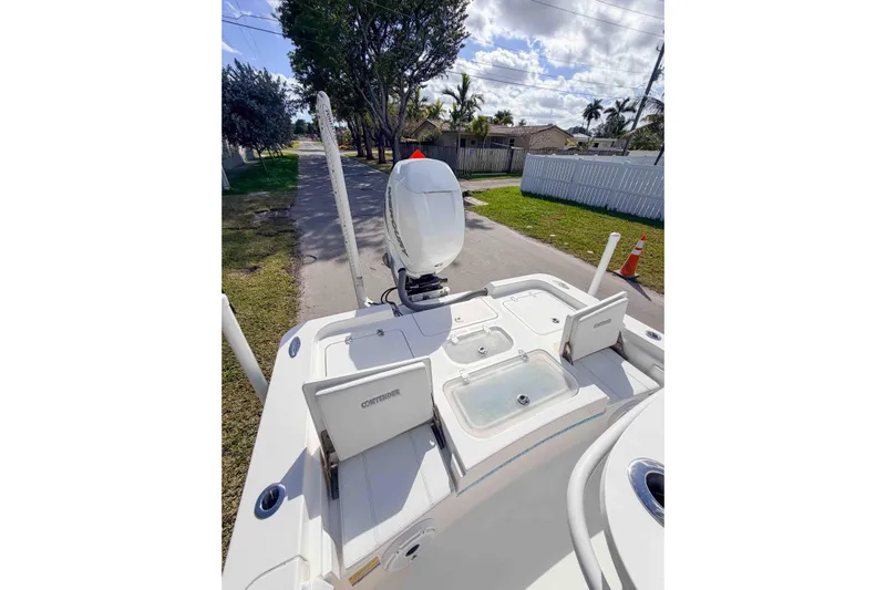 Yacht Photos Pics 2023 Contender 26 Bay boat with outboard motor, parked on a sunny street.