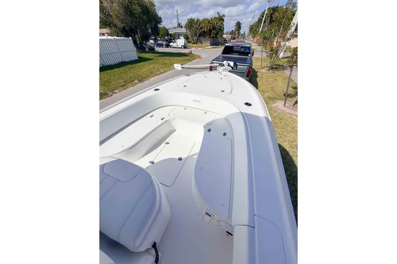  Yacht Photos Pics 2023 Contender 26 Bay boat on trailer, parked on a residential street.