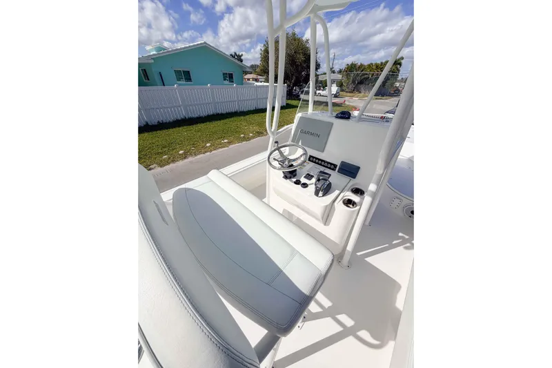  Yacht Photos Pics 2023 Contender 26 Bay boat console with Garmin navigation, steering wheel, and controls.