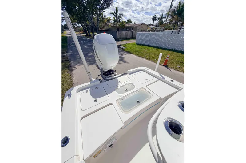  Yacht Photos Pics 2023 Contender 26 Bay boat with outboard motor and storage compartments.